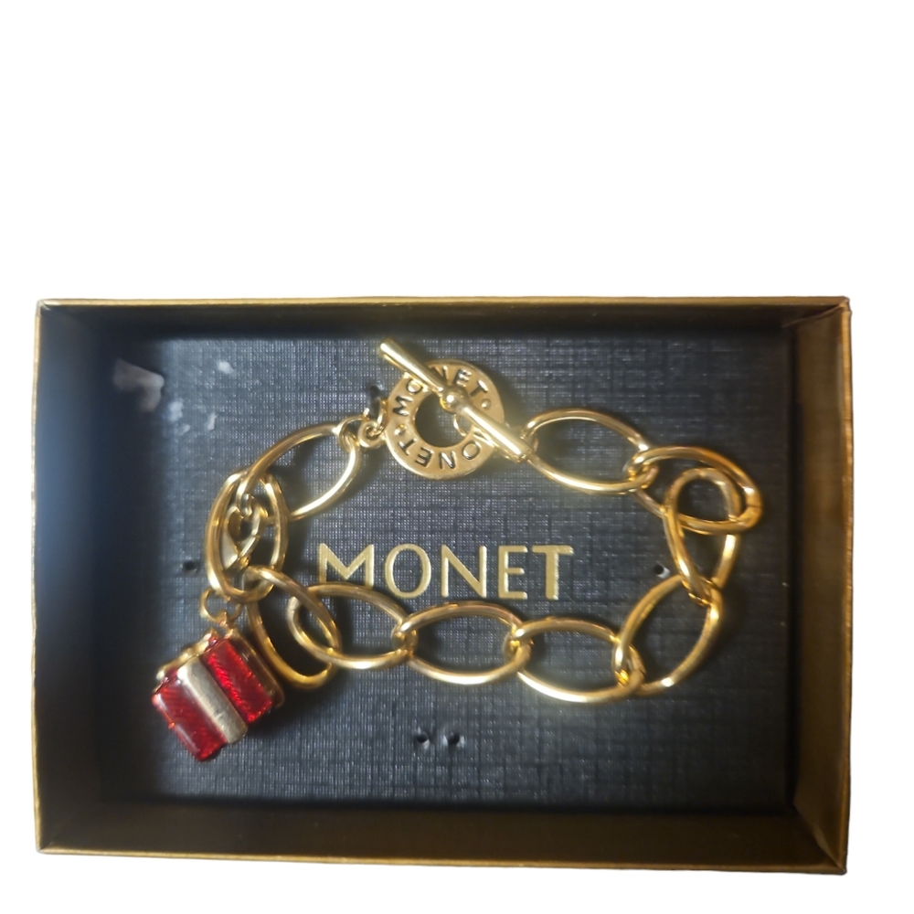 Vintage Monet Gold Toned Charm Bracelet 7" has present charm on it still on box
